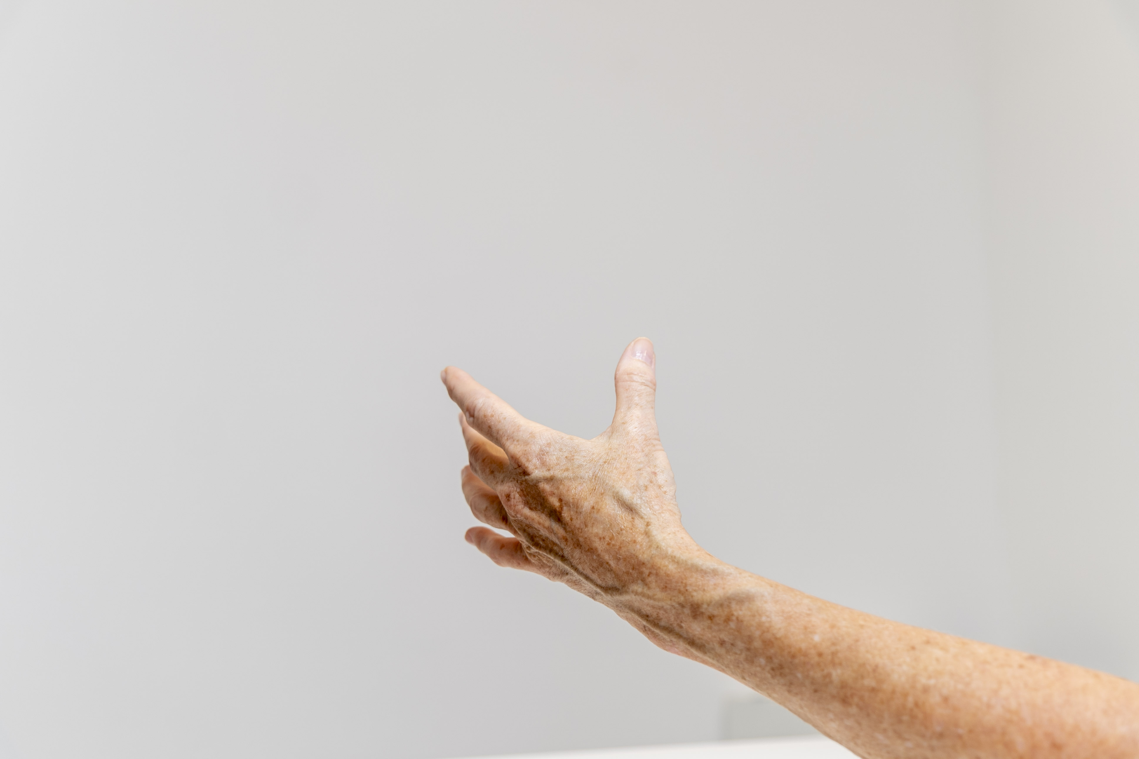 Open hand in front of wall